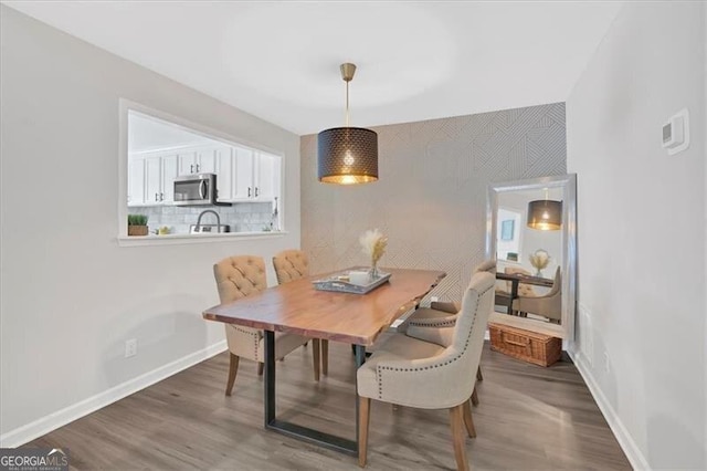 dining room with baseboards and wood finished floors