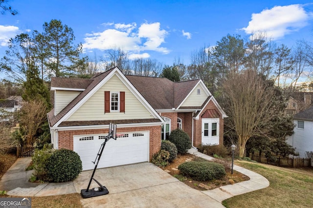 view of front of property with fence, concrete driveway, and brick siding