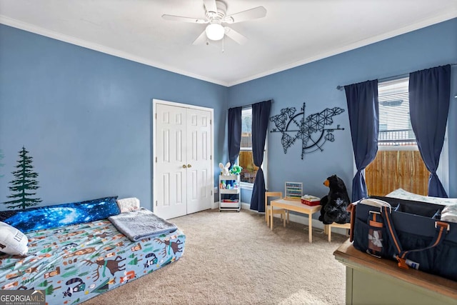 bedroom featuring carpet floors, ornamental molding, multiple windows, and a closet