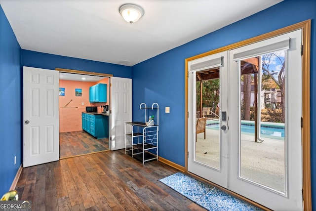 doorway with french doors, dark wood finished floors, and baseboards