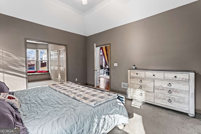 bedroom featuring carpet, visible vents, crown molding, and baseboards