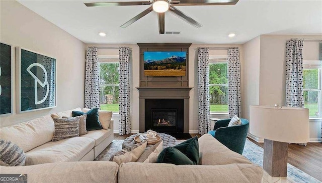 living room featuring recessed lighting, a large fireplace, wood finished floors, visible vents, and a ceiling fan