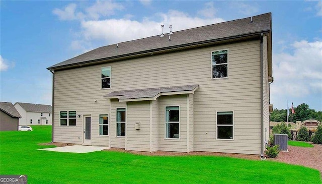 rear view of property with a yard, a patio, and central AC unit