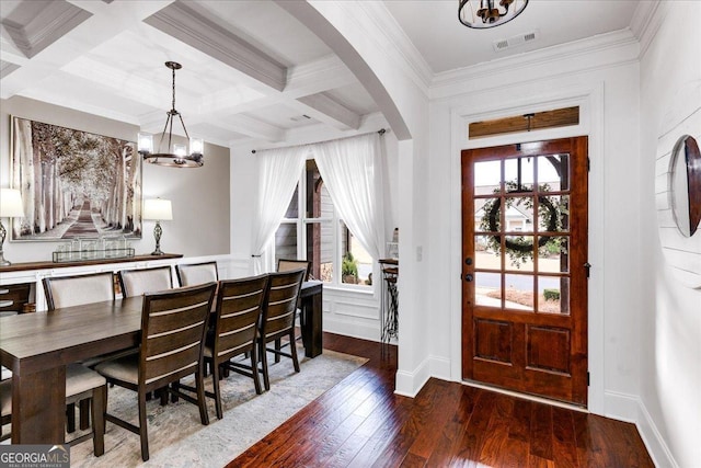 entryway with visible vents, arched walkways, coffered ceiling, hardwood / wood-style flooring, and beam ceiling