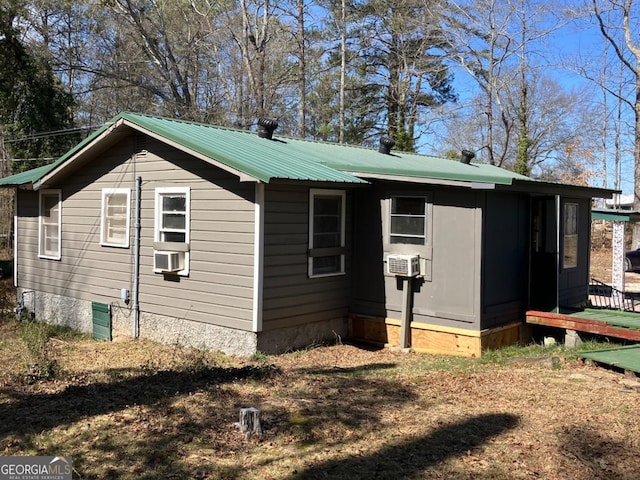 view of side of property with metal roof