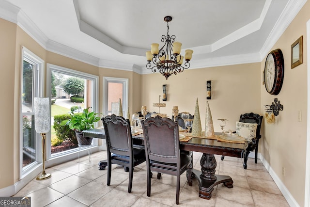 dining area featuring a chandelier, a tray ceiling, baseboards, and light tile patterned floors