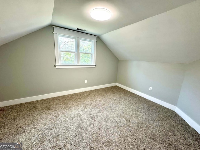 bonus room featuring vaulted ceiling, carpet, visible vents, and baseboards