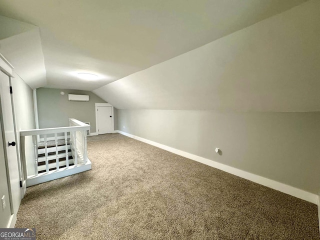 bonus room featuring lofted ceiling, baseboards, a wall mounted air conditioner, and carpet flooring