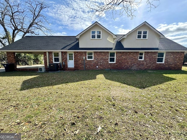 view of front of house with central air condition unit, a front lawn, and brick siding