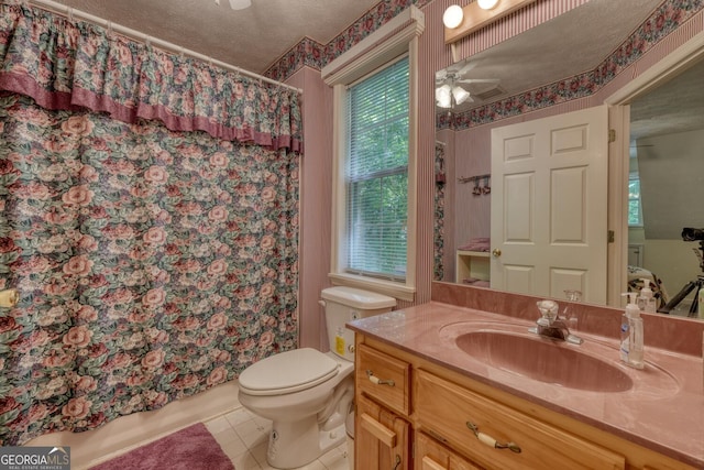 full bathroom with ceiling fan, a textured ceiling, tile patterned flooring, toilet, and vanity