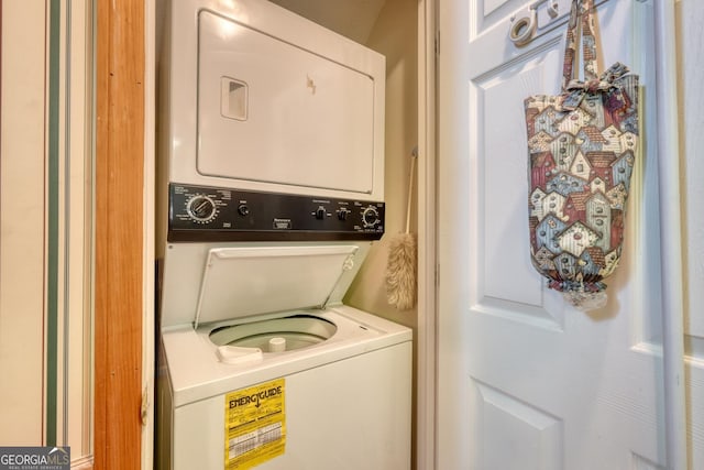 clothes washing area featuring laundry area and stacked washer / drying machine