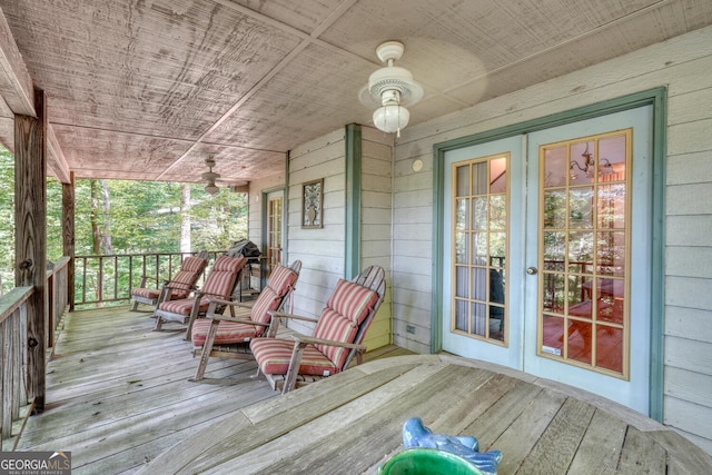 deck featuring covered porch and french doors