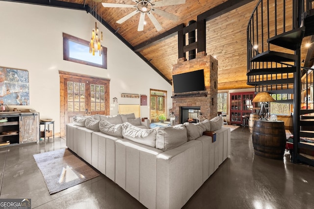 living room with beamed ceiling, plenty of natural light, wooden ceiling, and a ceiling fan