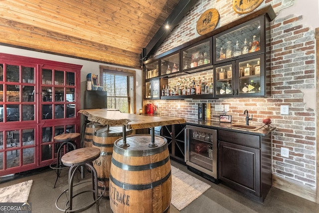 bar featuring brick wall, a sink, indoor wet bar, vaulted ceiling, and wine cooler