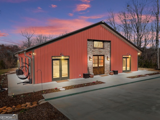 outdoor structure at dusk with french doors