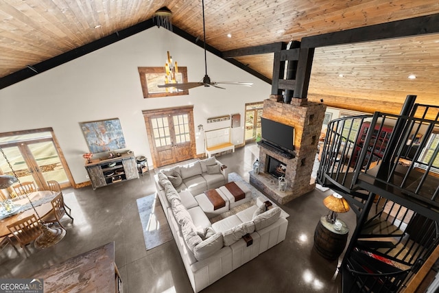 living area with a ceiling fan, a stone fireplace, wood ceiling, and high vaulted ceiling