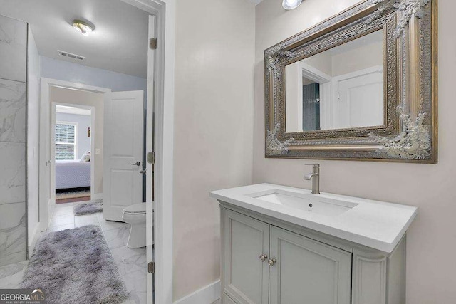 bathroom with toilet, visible vents, vanity, marble finish floor, and ensuite bath