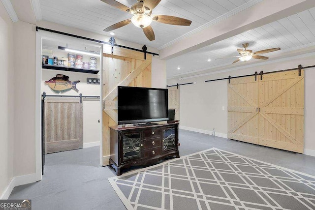 living area featuring baseboards, a barn door, concrete floors, and crown molding