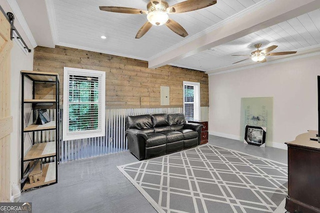 living area with a barn door, wood walls, wood ceiling, a ceiling fan, and ornamental molding