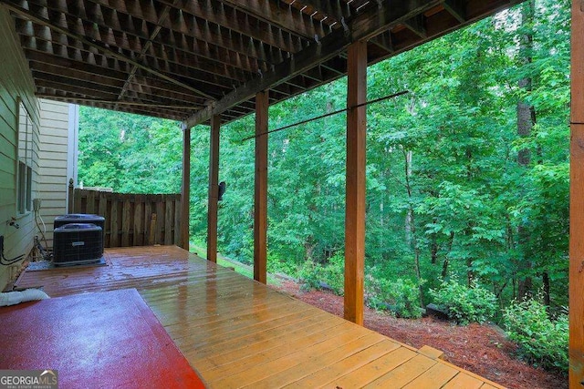 wooden terrace with fence and central air condition unit