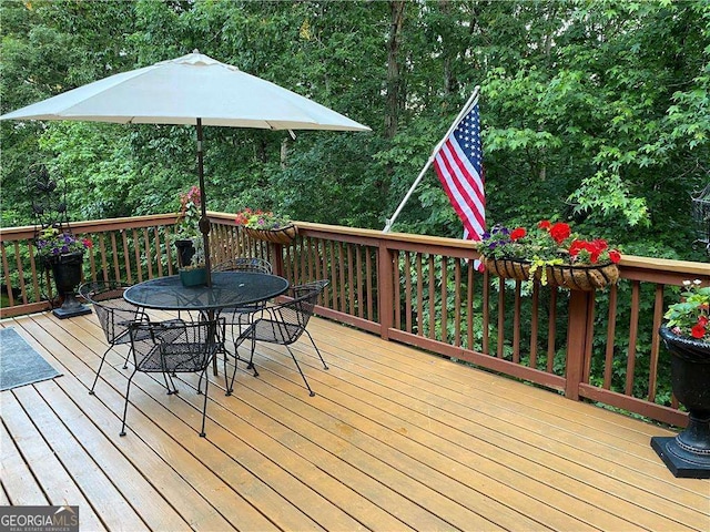 wooden terrace with outdoor dining area