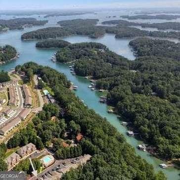 drone / aerial view with a water view and a forest view