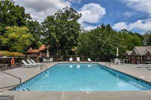 pool with fence and a patio