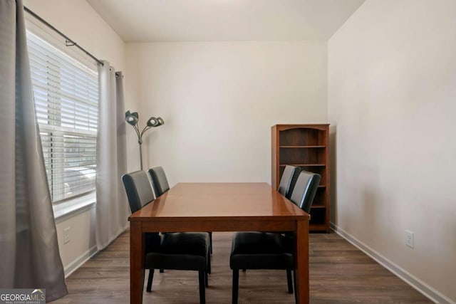 dining area featuring baseboards and wood finished floors