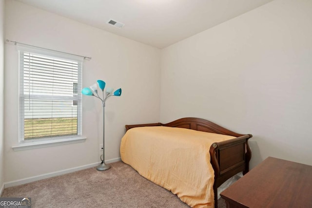 carpeted bedroom with baseboards and visible vents