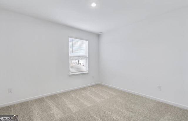 carpeted spare room with baseboards