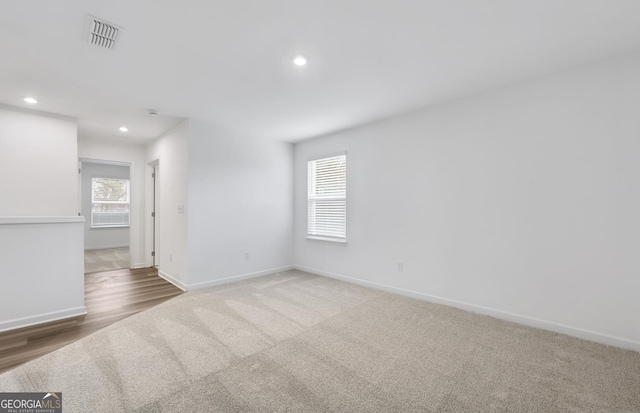 unfurnished room with visible vents, baseboards, a wealth of natural light, and recessed lighting