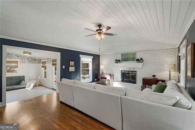 unfurnished living room with lofted ceiling, wooden ceiling, a fireplace, and wood finished floors