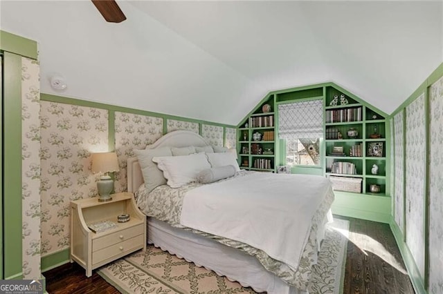 bedroom featuring lofted ceiling, ceiling fan, wood finished floors, and wallpapered walls