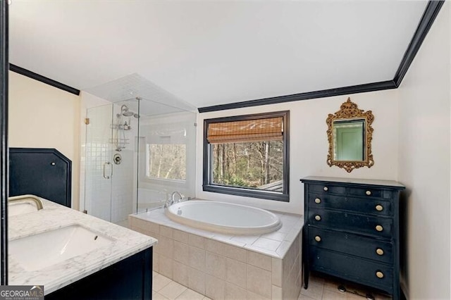 bathroom featuring a garden tub, crown molding, double vanity, a sink, and a shower stall