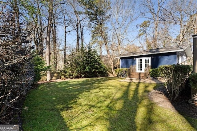 view of yard with entry steps and french doors