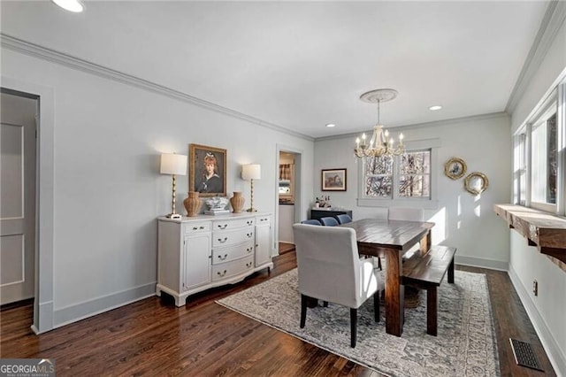 dining space featuring a notable chandelier, visible vents, baseboards, ornamental molding, and dark wood-style floors