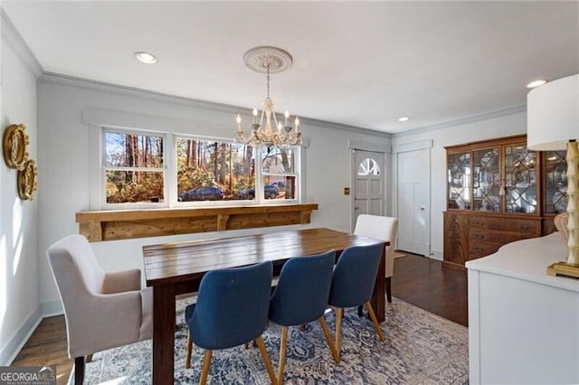 dining space with ornamental molding, recessed lighting, a notable chandelier, and wood finished floors