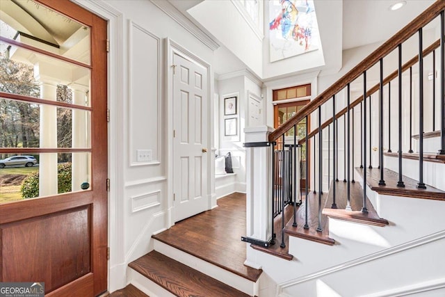 foyer featuring stairway, wood finished floors, and recessed lighting