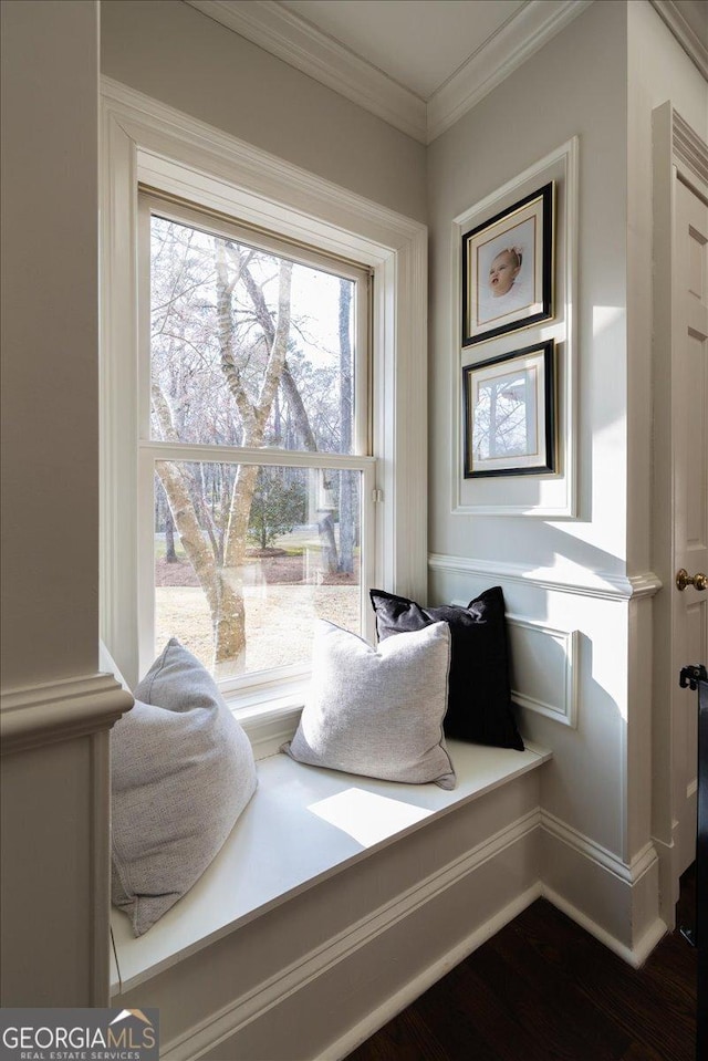 sitting room featuring ornamental molding and dark wood-style flooring