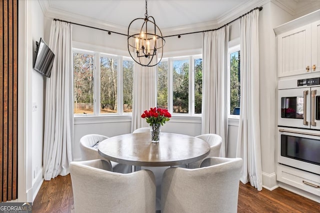 dining area with an inviting chandelier, baseboards, dark wood finished floors, and crown molding