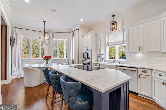 kitchen featuring ornamental molding, a center island, white dishwasher, black electric stovetop, and a sink