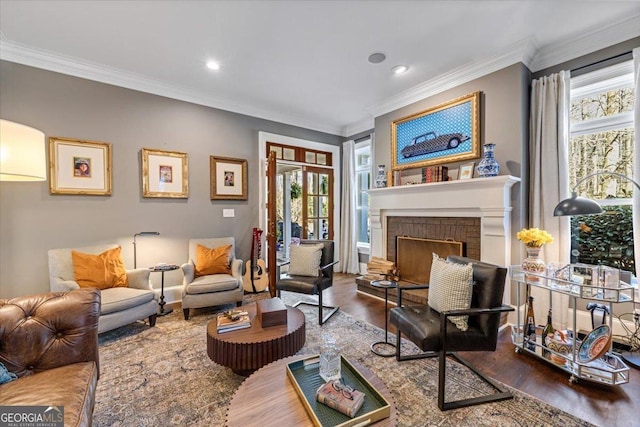 living area with ornamental molding, recessed lighting, a fireplace, and wood finished floors