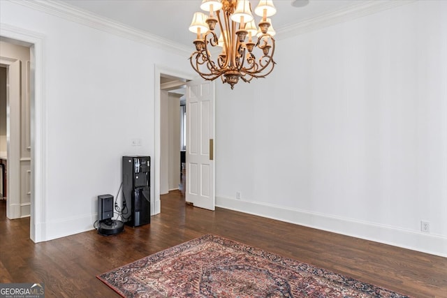 interior space with ornamental molding, a notable chandelier, dark wood finished floors, and baseboards