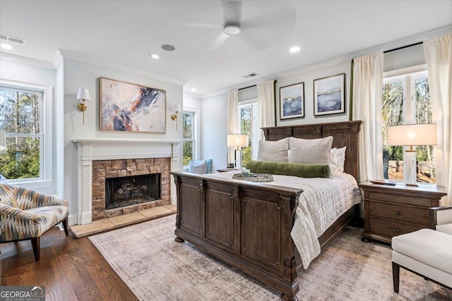 bedroom featuring multiple windows, visible vents, and crown molding