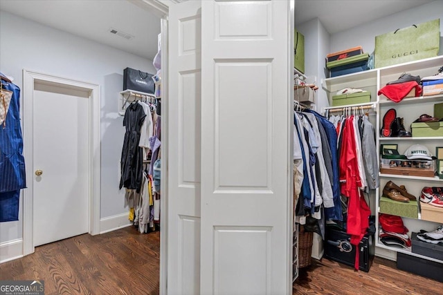 spacious closet featuring wood finished floors and visible vents