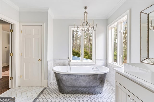 bathroom with ornamental molding and a healthy amount of sunlight