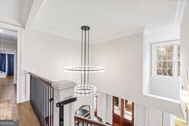 room details with wood finished floors, crown molding, baseboards, and an inviting chandelier