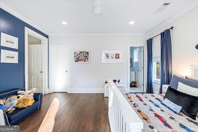 bedroom featuring baseboards, visible vents, dark wood finished floors, and ornamental molding