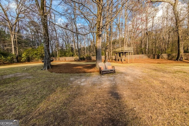 view of yard featuring a playground and fence