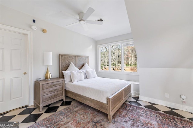 bedroom featuring ceiling fan, visible vents, baseboards, vaulted ceiling, and tile patterned floors